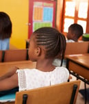 Back view of African kids in an elementary school class