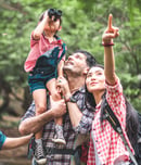 A group of young Asians are planning and looking at maps for camping in the forest.Asian and caucasian are backpackers.Tourism, adventure and summer vacation concept