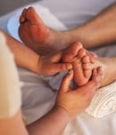 Closeup, feet and spa therapist with massage, pedicure and relax with health, wellness and acupress.