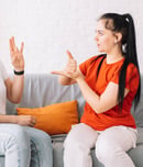 Girl asking for help in sign language.