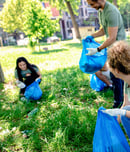 Multiethnic group of volunteers with garbage bags cleaning city