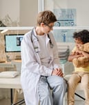 Pediatrist talking to child at office