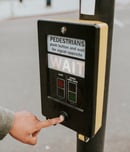 Person pressing a pedestrian cross push button