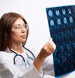Doctor examines an MRI image of the patient's head.