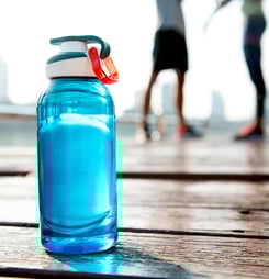 Bottle of water on plank in a park