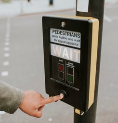 Person pressing a pedestrian cross push button