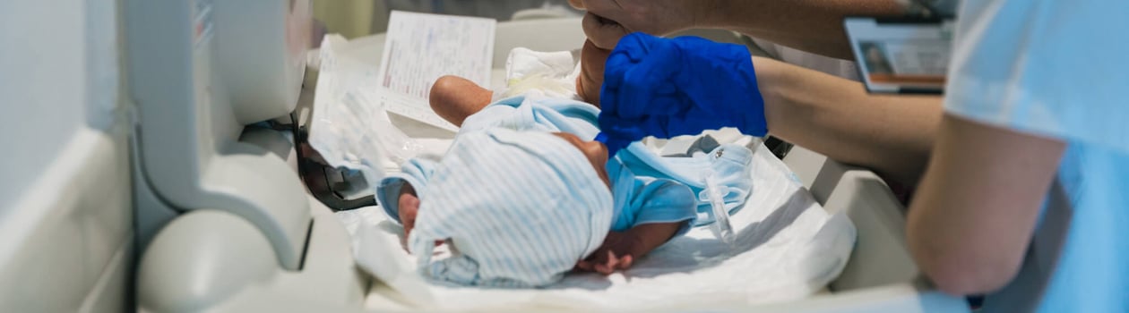 Team of professional doctors and nurses examining newborn baby at the hospital.