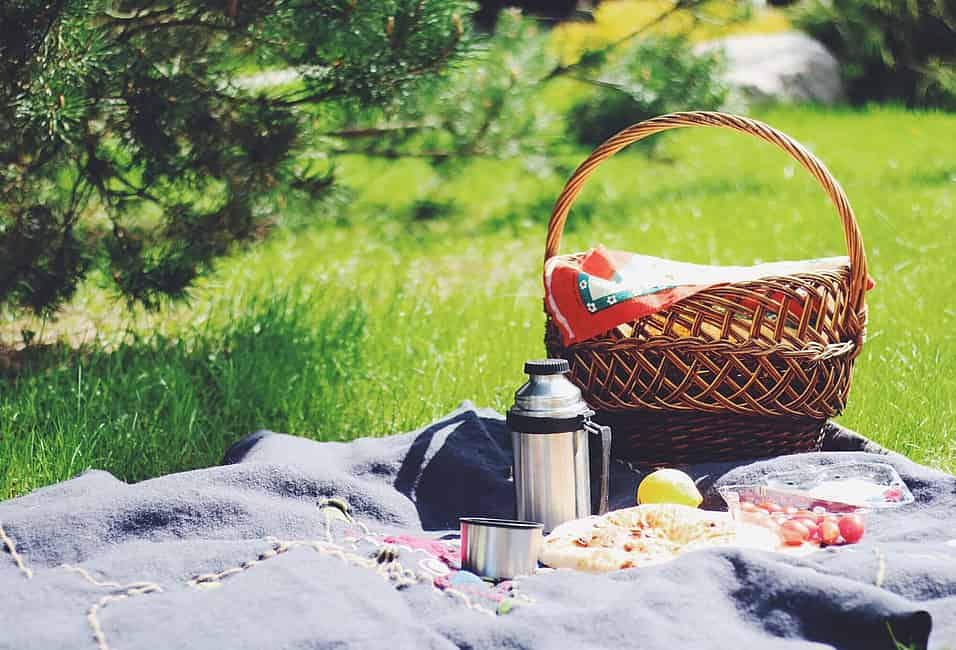 Close Up Of Picnic Party In The Park Drink Table With Large