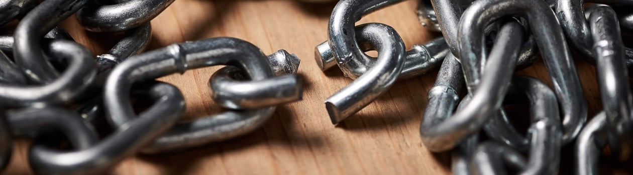 Shot of metal chains with a broken link