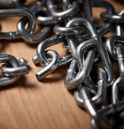 Shot of metal chains with a broken link