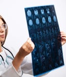 Doctor examines an MRI image of the patient's head.