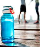 Bottle of water on plank in a park