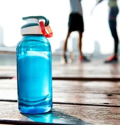 Bottle of water on plank in a park