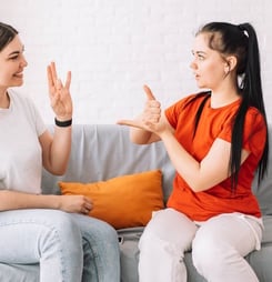 Girl asking for help in sign language.
