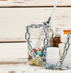 Chains over bottles with pills.