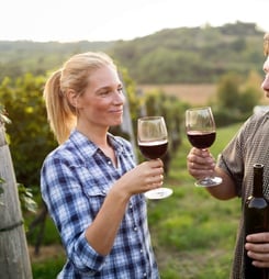 Wine grower family in vineyard before harvesting